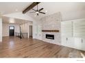 Spacious living room with hardwood floors, fireplace, and built-in shelves at 0 Hwy 52, Erie, CO 80516