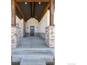 Covered porch with stone columns and wood beams at 0 Hwy 52, Erie, CO 80516