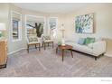 Living room featuring bay window, sofa and accent chairs at 1486 Clover Creek Dr, Longmont, CO 80503