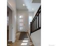 Bright entryway with wood-look floors and staircase at 2371 Stonecrop Way, Superior, CO 80027