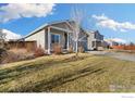 Landscaped yard with a view of the house and neighborhood at 2865 Big Thunder Rd, Berthoud, CO 80513