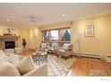 Bright living room with hardwood floors, fireplace and large windows at 1455 Chestnut Pl, Boulder, CO 80304