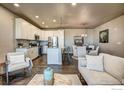 Open floorplan living area with adjacent kitchen and dining at 410 High Point Dr # 105, Longmont, CO 80504