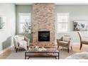 Spacious living room featuring a stunning stone fireplace at 858 Meadowlark Ln, Louisville, CO 80027