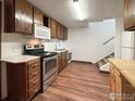 Galley kitchen with stainless steel appliances and wood cabinets at 131 Bowen St, Longmont, CO 80501