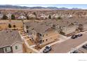 Aerial view of townhomes in a community setting, showing surrounding landscape and mountain views at 15536 W 64Th Loop # A, Arvada, CO 80007