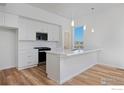 Modern white kitchen with stainless steel appliances and an island at 733 Kubat Ln # A, Longmont, CO 80503
