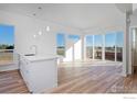 Bright living room with hardwood floors and sliding glass doors to balcony at 733 Kubat Ln # A, Longmont, CO 80503
