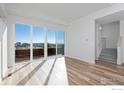Spacious living area with hardwood floors and access to deck at 733 Kubat Ln # A, Longmont, CO 80503