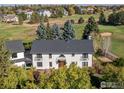 An aerial view showcasing a two story house with a golf course view and lush landscaping at 1490 Saint Andrews Dr, Broomfield, CO 80020