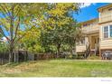 Daytime view of charming townhome with lush landscaping and tree at 3405 Valmont Rd # A, Boulder, CO 80301