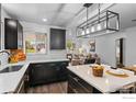 Modern kitchen featuring dark cabinets, white countertops, subway tile, and gold hardware at 450 S Decatur St, Denver, CO 80219