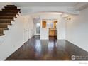 Spacious living room with dark hardwood floors and white walls at 4800 Osage Dr # 1, Boulder, CO 80303