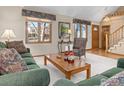 Living room with hardwood floors, large windows, and comfortable seating at 1232 Twin Peaks Cir, Longmont, CO 80503