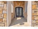 Elegant entryway with double doors and stone facade at 1615 Stardance Cir, Longmont, CO 80504