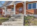 Steps leading up to the front porch of a charming home at 2409 Winding Dr, Longmont, CO 80504