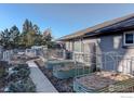 Landscaped side yard with raised garden beds and walkway at 3660 N Glencoe St, Denver, CO 80207