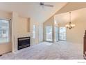 Living room with vaulted ceiling, fireplace and sliding glass doors at 2127 S Scranton Way, Aurora, CO 80014