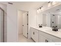 Double vanity bathroom with modern fixtures and a large mirror at 2848 South Flat Cir, Longmont, CO 80503