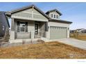 Craftsman style home with gray siding, stone accents, and a two-car garage at 3051 Newfound Lake Rd, Berthoud, CO 80513