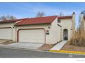 Tan exterior home with red tile roof and attached garage at 1307 Bosque St, Broomfield, CO 80020