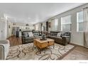 Open-concept living room and kitchen with a large sectional sofa at 2262 Monte Vista St, Fort Lupton, CO 80621