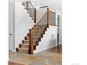 Wooden staircase with wrought iron railing and carpet at 24230 E Moraine Pl, Aurora, CO 80016