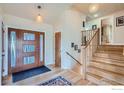 Bright and airy entryway with hardwood floors and a modern front door at 2560 Briarwood Dr, Boulder, CO 80305