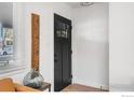 Modern entryway with black door and wood floors at 320 Vivian St, Longmont, CO 80501