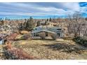Ranch home situated on a large lot with city views in the background at 34 S Raleigh St, Denver, CO 80219