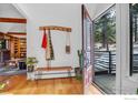 Front entry with wood bench, coat rack and view to deck at 160 Bristlecone Way, Boulder, CO 80304