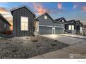 Gray two-story home with attached garage and landscaping at 1784 Mount Meeker Ave, Berthoud, CO 80513