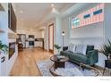 Open living area with kitchen, fireplace, and green couch at 1998 Foxtail Ln # B, Lafayette, CO 80026