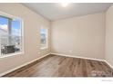 Bright living room with hardwood floors and large windows at 357 Canyonlands St, Berthoud, CO 80513