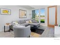 Modern living room with gray sectional sofa and large windows at 440 Levi Ln # A, Lafayette, CO 80026