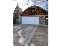 House exterior boasts wood siding, stone accents, and a white garage door at 3617 S Fundy Way, Aurora, CO 80013