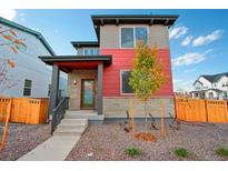 Modern two-story home with a mix of stone and red siding at 21124 E 63Rd Dr, Aurora, CO 80019
