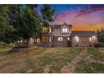 Brick two-story house with attached garage and landscaping at 102 Staghorn Way, Franktown, CO 80116