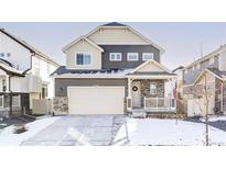 Two-story house with gray and beige siding, stone accents, and a two-car garage at 998 Larkspur Dr, Erie, CO 80516