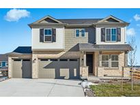 Two-story house with stone and siding, two-car garage, and landscaped yard at 39650 Congress Ln, Elizabeth, CO 80107