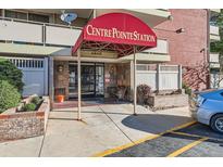 Centre Pointe Station building entrance with awning and brick facade at 4600 E Asbury Cir # 106, Denver, CO 80222