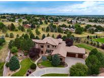 Aerial view of a luxurious house with landscaping and mountain views at 19333 E Briarwood Pl, Aurora, CO 80016