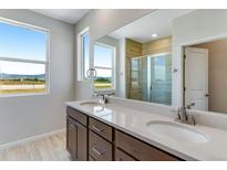 Bathroom boasts dual sinks, quartz countertops, and a large shower at 1783 Mount Meeker Ave, Berthoud, CO 80513