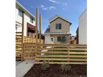 Modern two-story home with a landscaped front yard and wooden fence at 6907 Kendrick Ln, Arvada, CO 80007