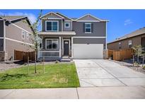 Charming two-story home with a welcoming front porch and attached garage at 760 N Allium St, Watkins, CO 80137