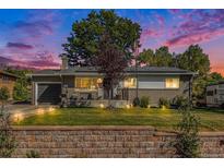Single story home with landscaped yard and solar panels at 6772 Kipling St, Arvada, CO 80004