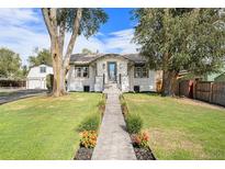 Charming craftsman style home with a landscaped front yard and walkway at 6983 W 68Th Ave, Arvada, CO 80003