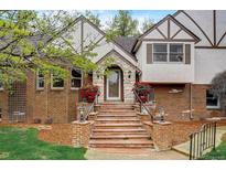 Brick house with a large front porch and landscaping at 12000 W 29Th Pl, Wheat Ridge, CO 80215