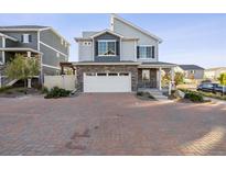 Two-story house with gray siding and a white garage door at 4606 N Quatar Ct, Aurora, CO 80019