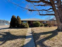 Brick ranch home with a spacious yard and mature trees at 3690 Leyden St, Denver, CO 80207